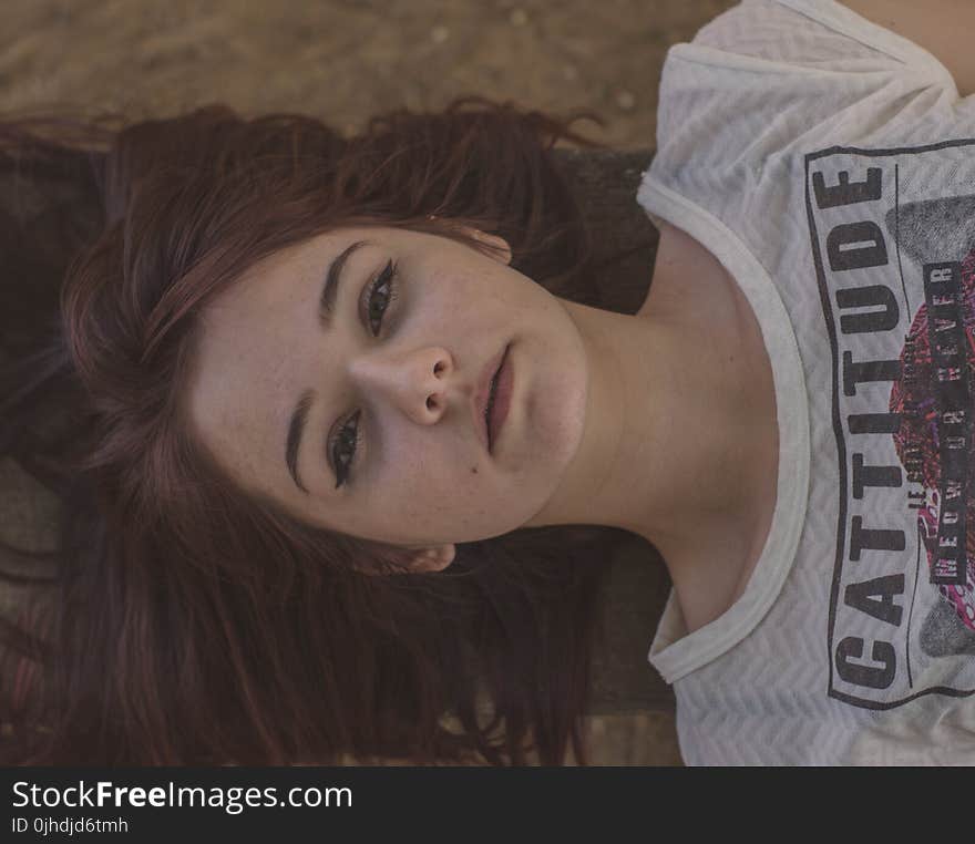 Woman Wearing White and Black Cattitude-printed Shirt