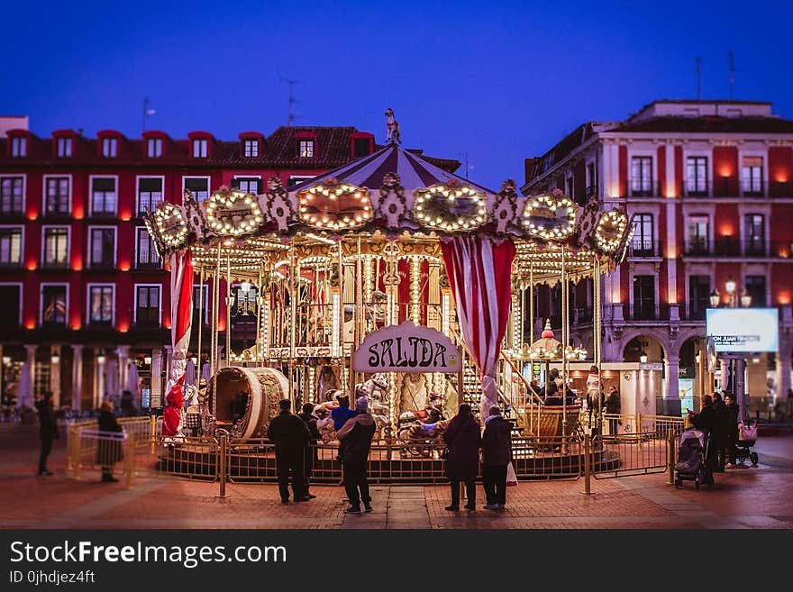 Group of People Standing at the Front of Carousel