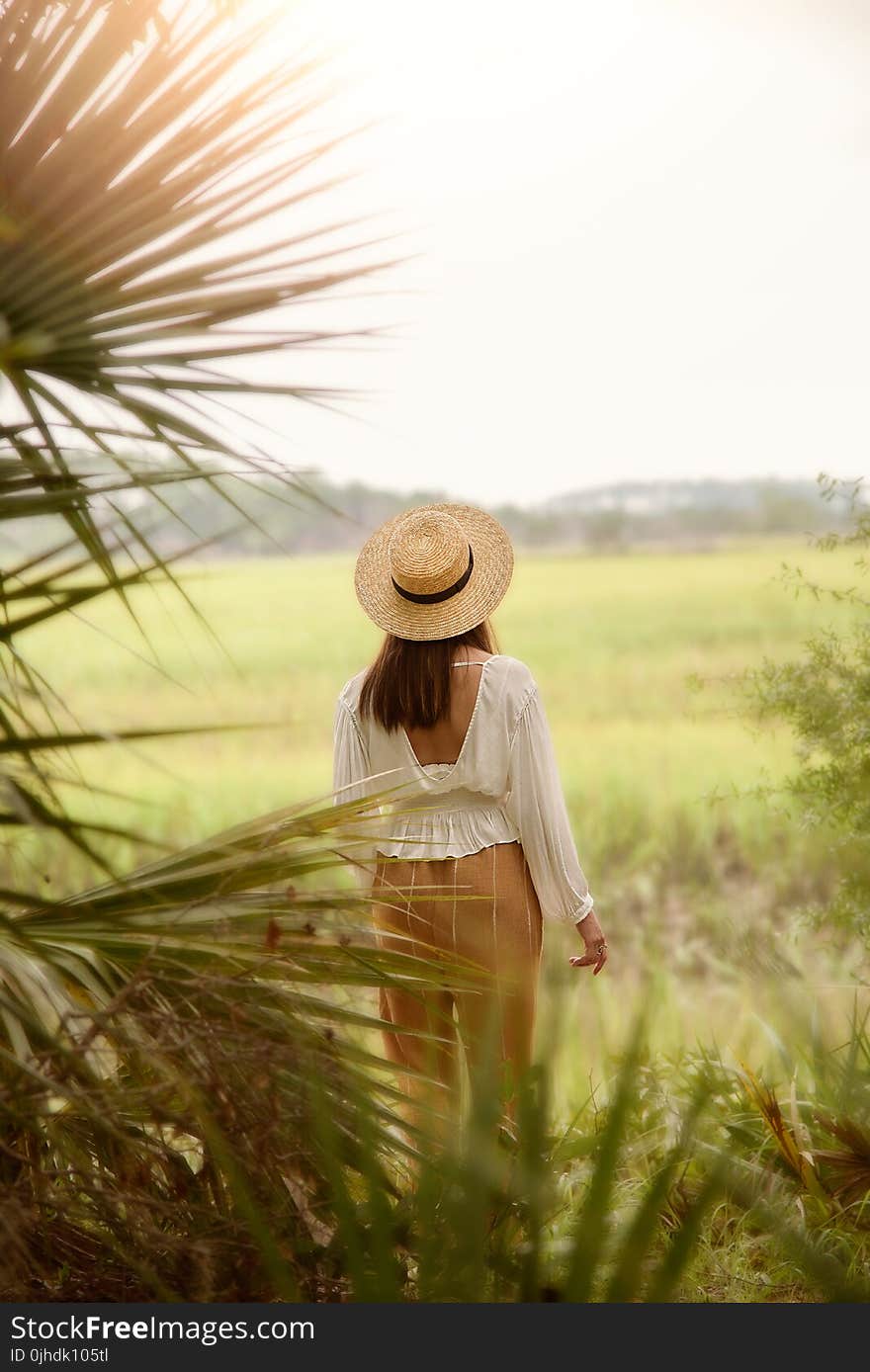 Woman in White Scoop-neck Long-sleeved Blouse With Brown Pants