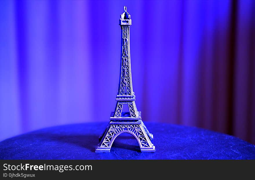 Eiffel Tower Miniature on Blue Textile