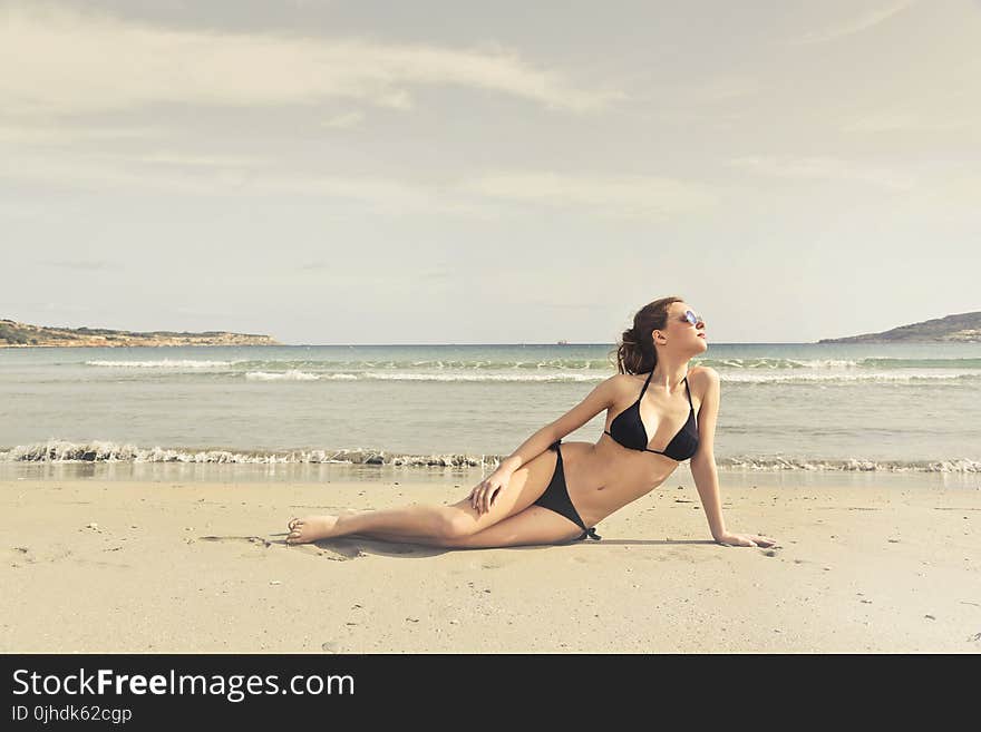 Woman in Black Bikini on Seashore