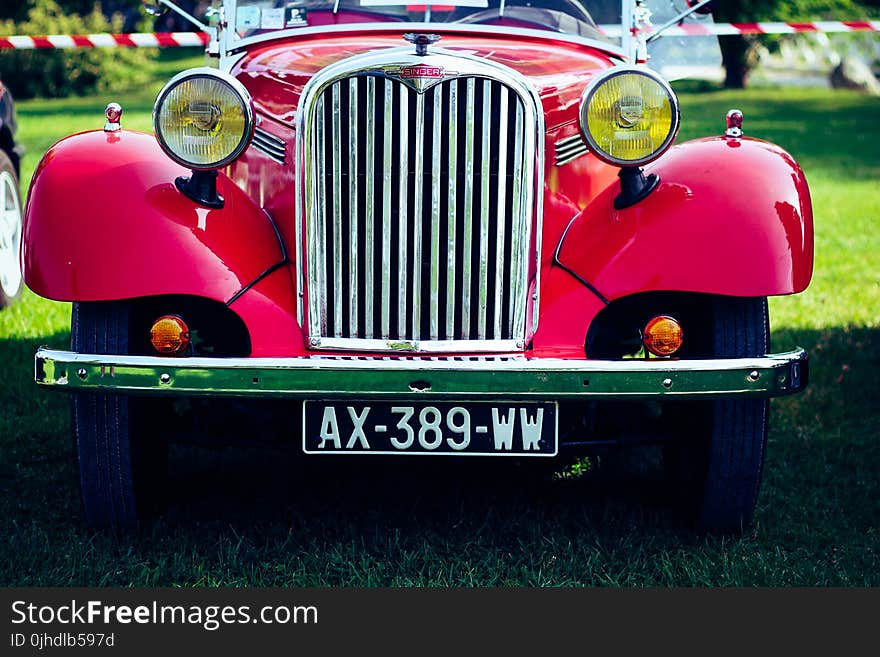 Classic Red Car on Green Grass