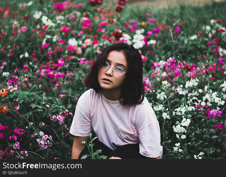 Girl in White T-shirt Surrounded by Flowers