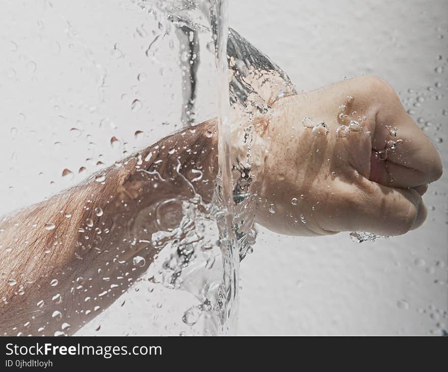 Person&#x27;s Left Fist Punching Water