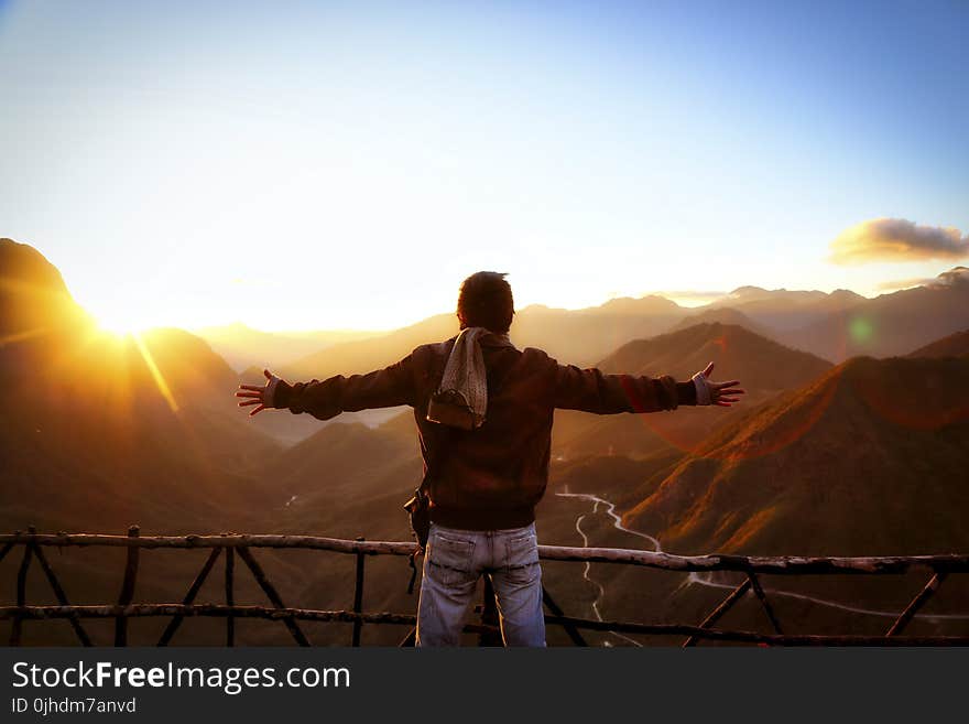 Man in Black Jacket Standing Near Sunset