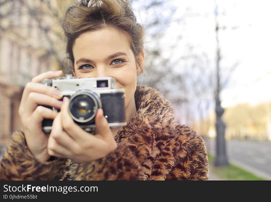 Woman Holding Black and Gray Camera Focus Photo