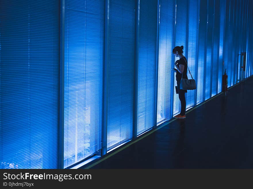 Woman Standing Near Blue Led Wall