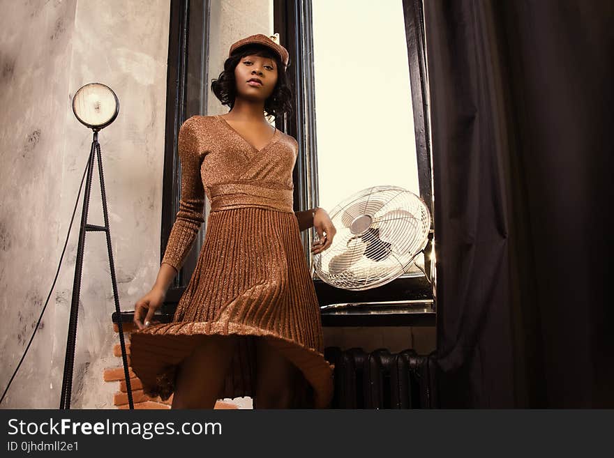 Woman in Long-sleeved Midi Dress Standing Near on Wall-mounted Fan