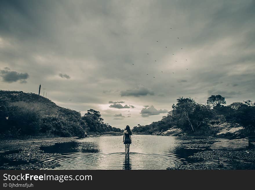 Grayscale Photo of Female on Body of Water