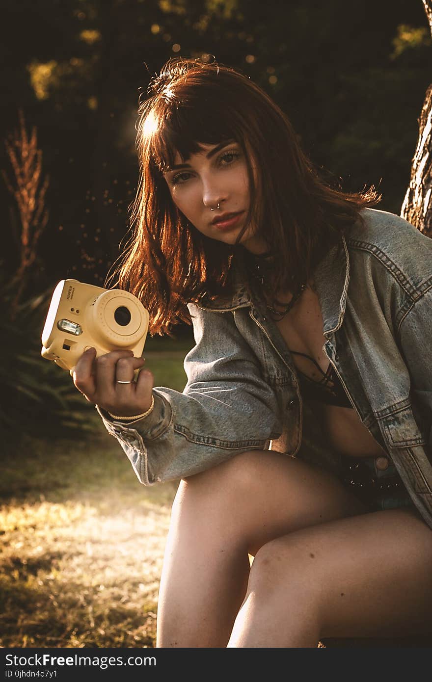 Women Wearing Blue Denim Jacket Holding Yellow Fujifil Instax Mini 8