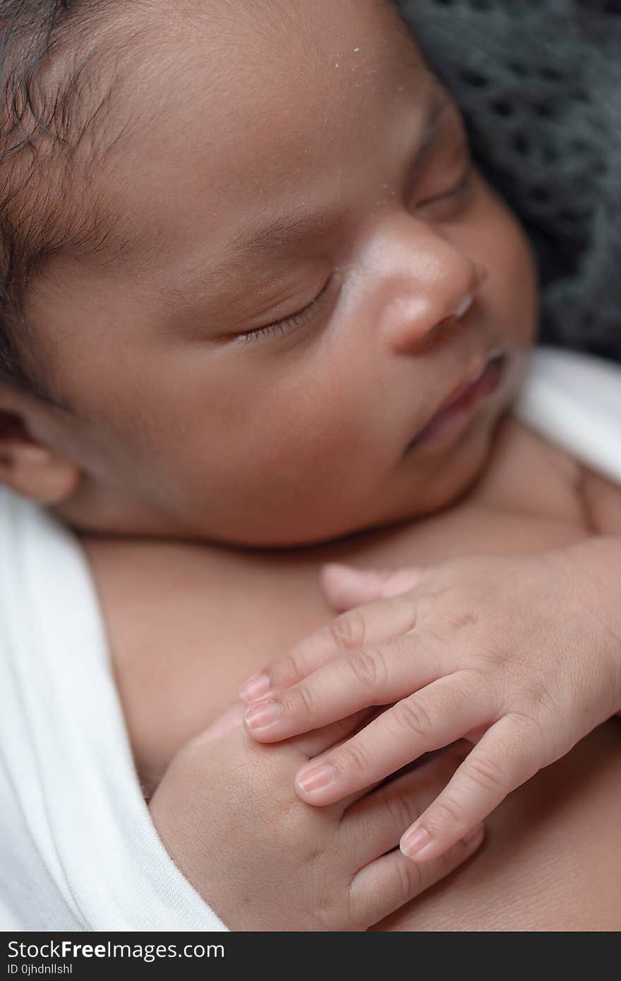 Baby Sleeping While Covered White Coat