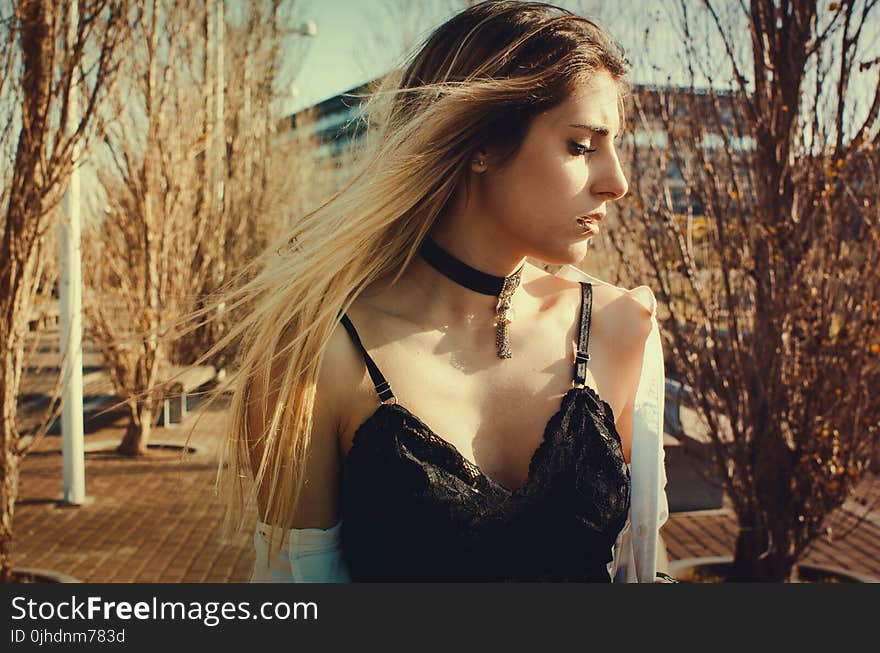 Woman Wearing Black Choker and Sleeveless Top Walking on Street