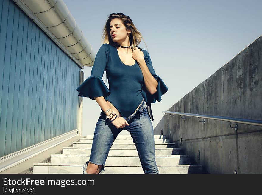 Woman Wearing Blue Scoop-neck Quartered Sleeve Shirt Posing