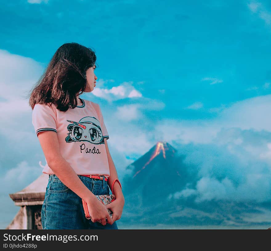 Photography of a Girl In Front of Erupting Volcano