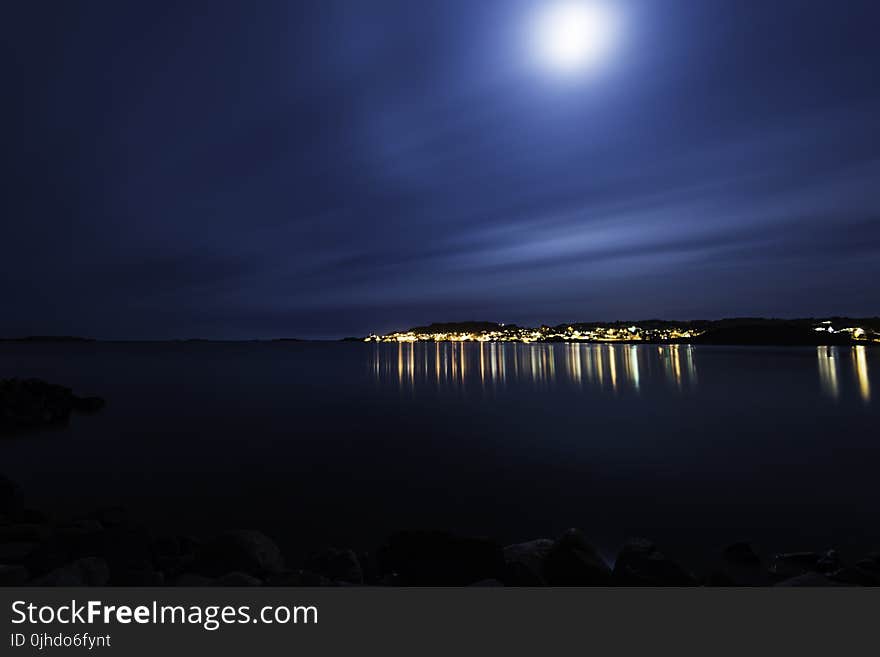 Silhouette of Mountain Beside Seashore