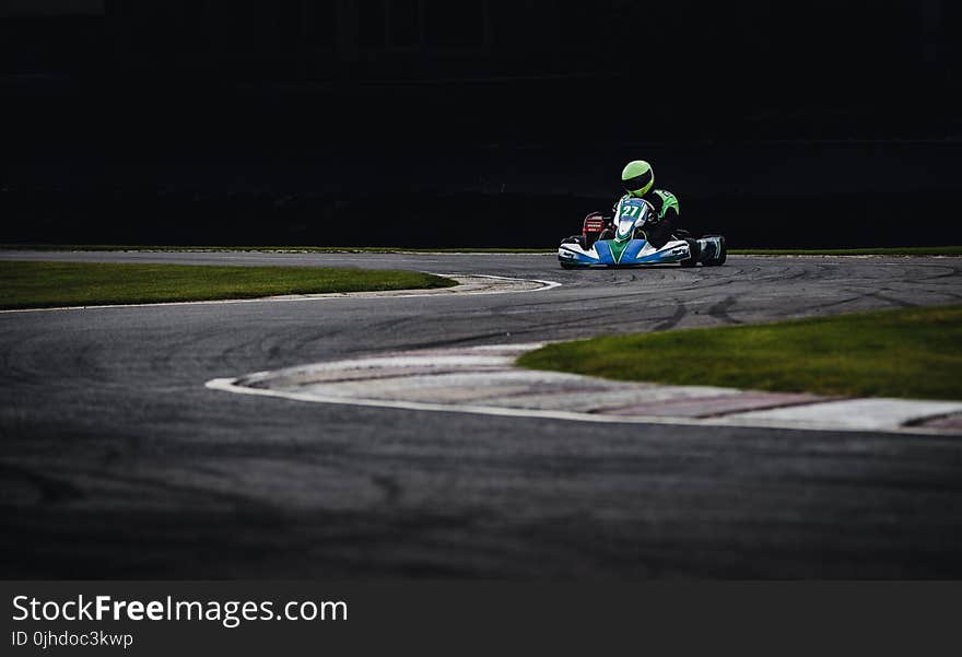 Man Wearing Green Helmet Riding Go Kart