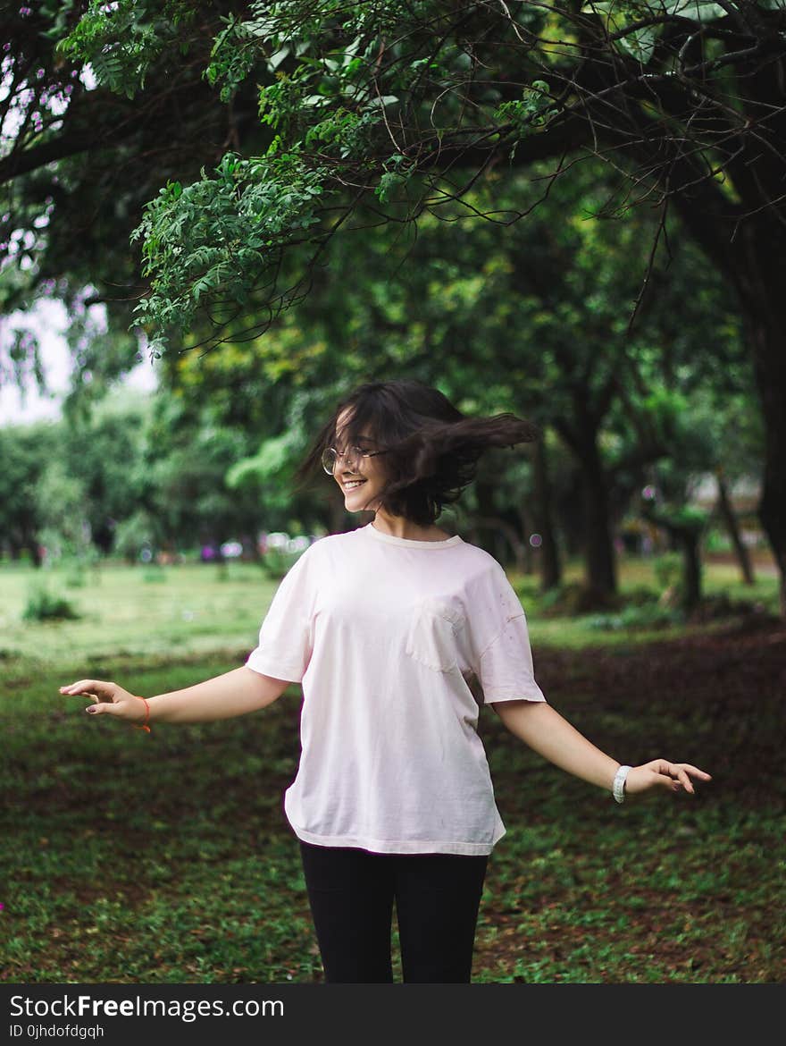 Photography of a Smiling Woman Near Trees