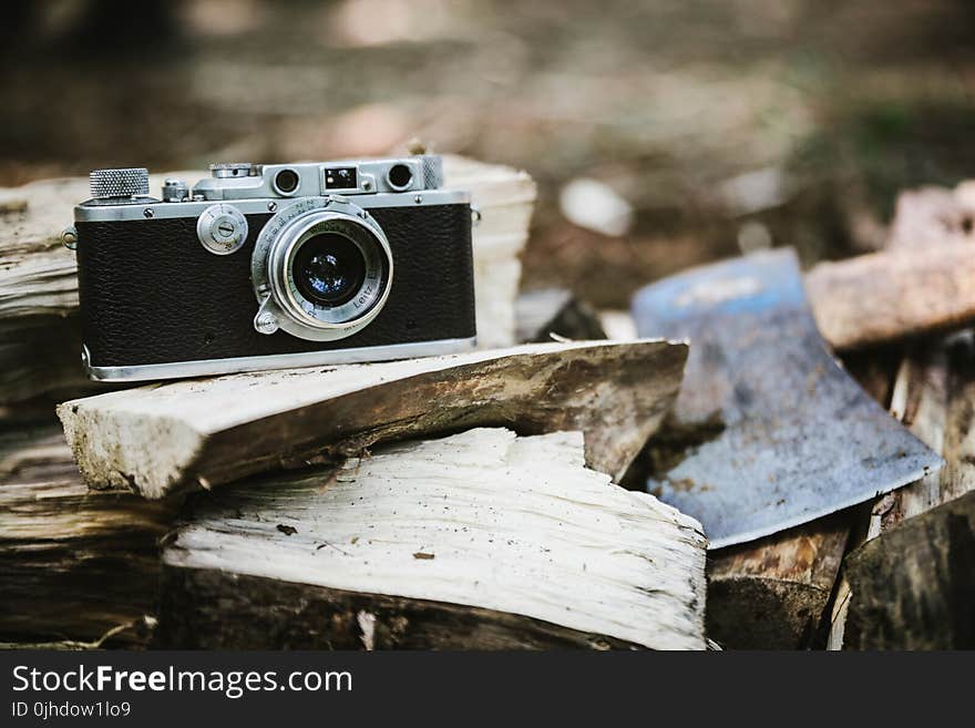 Black Bridge Camera on Wood Burner Beside Pickaxe