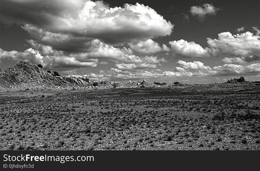 Grey Scale Photography of Open Field and Mountain