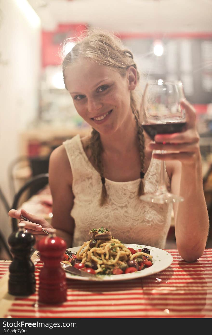 Woman in White Sleeveless Tops Holding Wine Glass