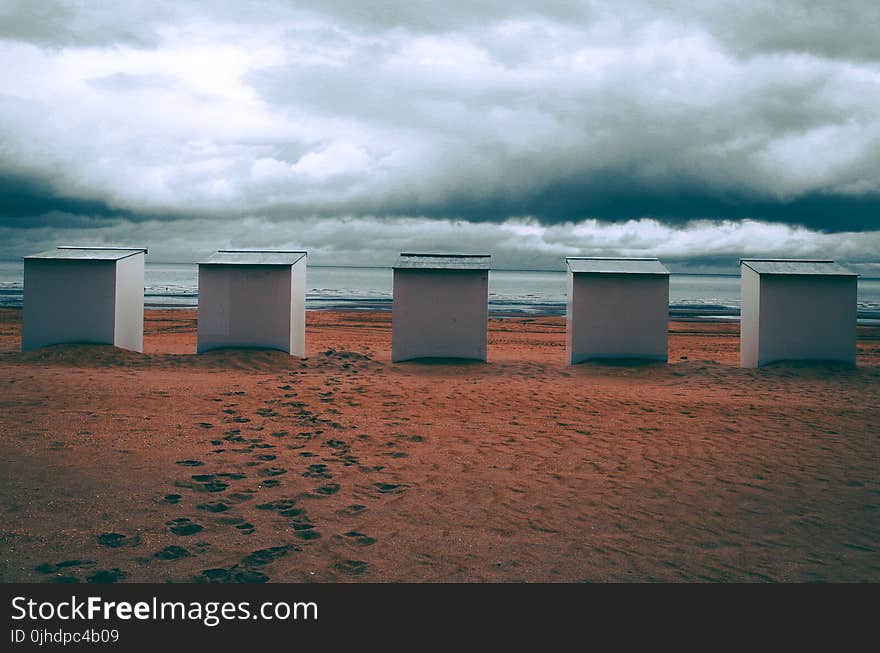 Five White Frames Near Body of Water