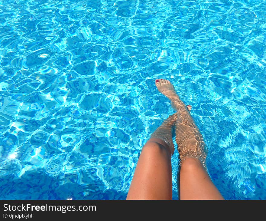 Person Feet Dipping on Pool