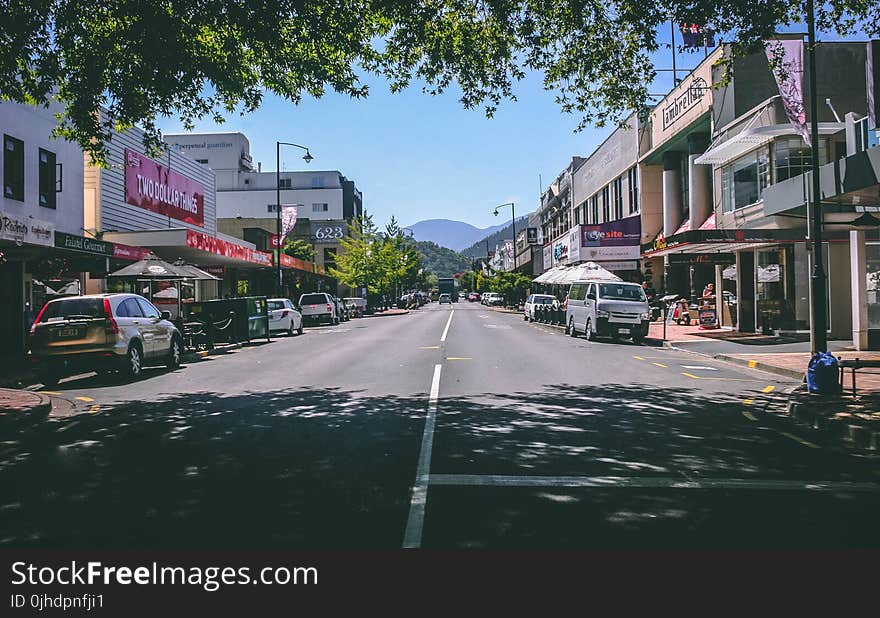 Photography of Roadway With Parked Cars