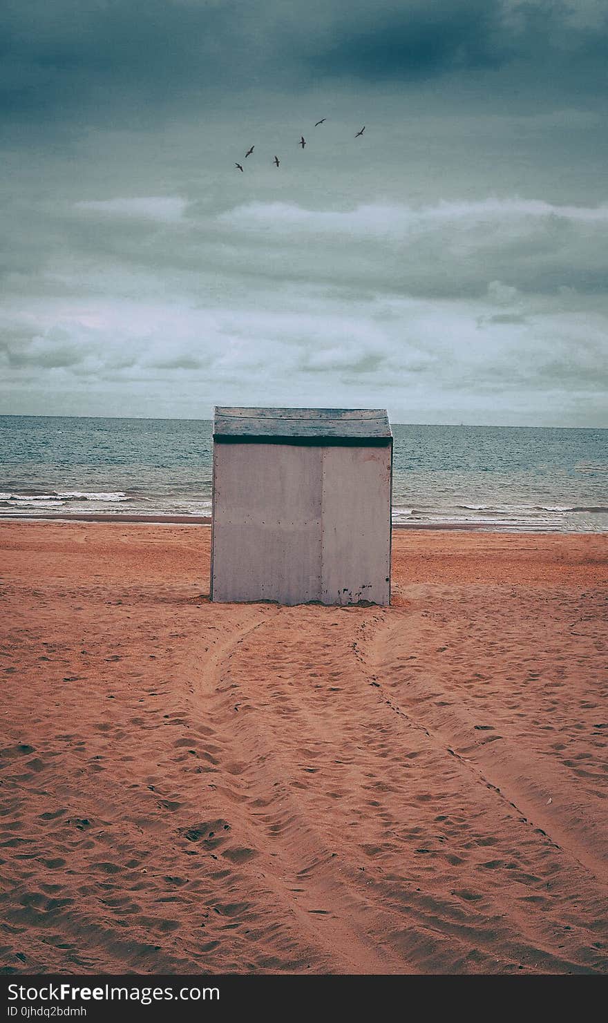 Gray Storage Shed on Brown Sand