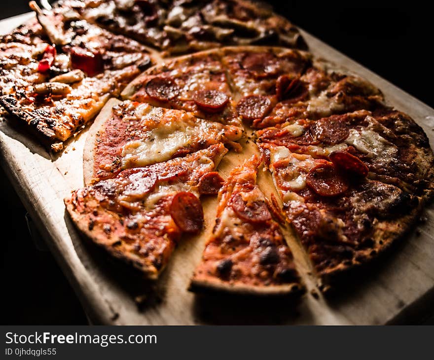 Pizza on Brown Wooden Board