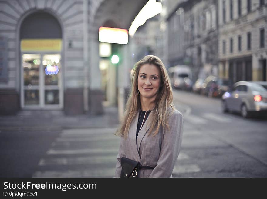 Woman in Gray Suit Jacket Near Gray Car