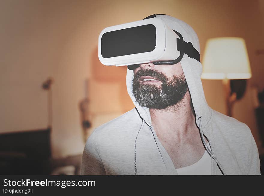 Man Wearing Gray Hoodie and White Virtual-reality Headset