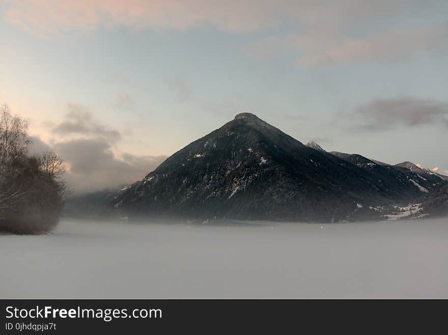 Black Mountain Under Cloudy Sky