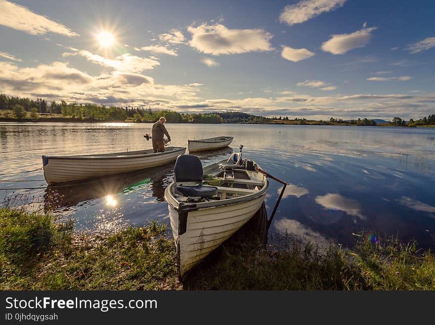 Fisherman on White Wooden Boat