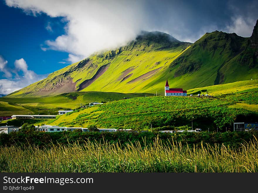 Green Field Near Mountain During Daytime