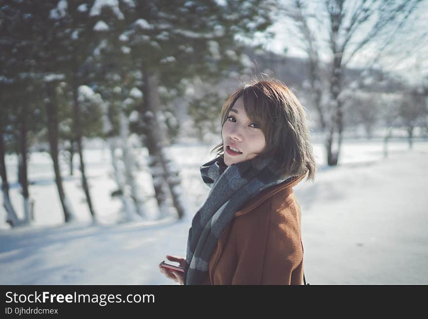 Photography of a Woman Wearing Gray Scarf