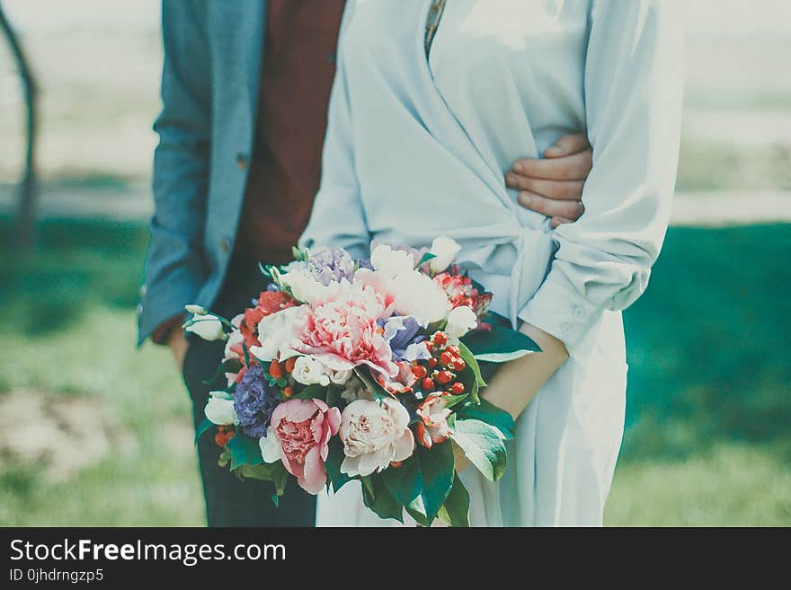 Man and Woman Standing on Grass Field