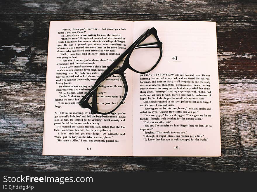 Photography of Eyeglasses on Top of Book