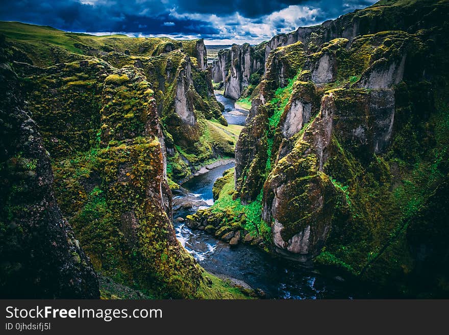 Photography Of Mountains Under Cloudy Skies