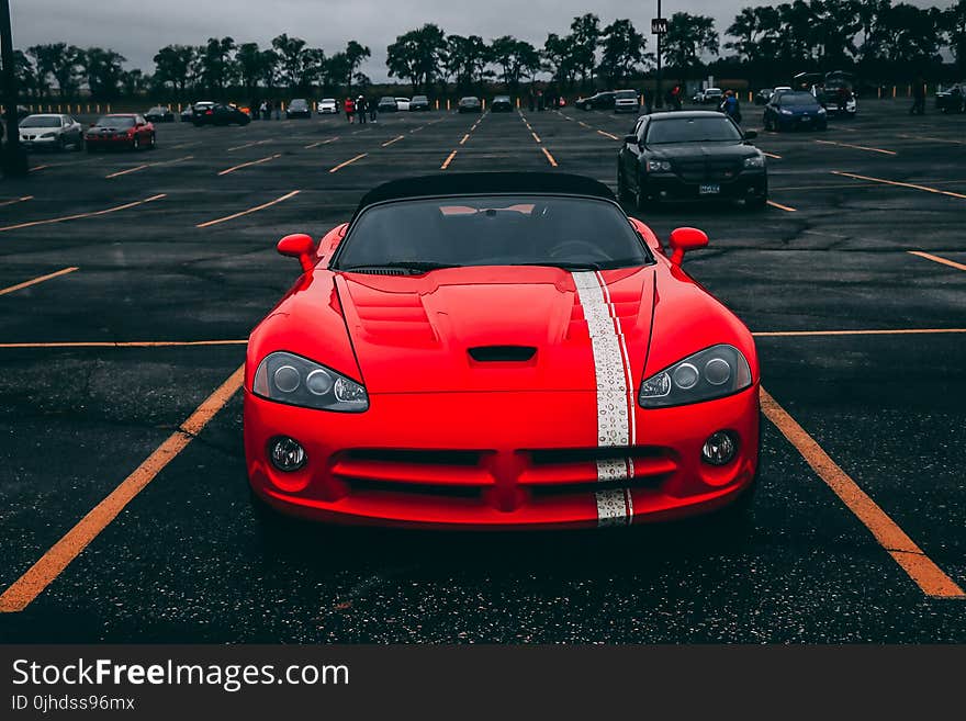 Red Convertible Coupe on Black Surface