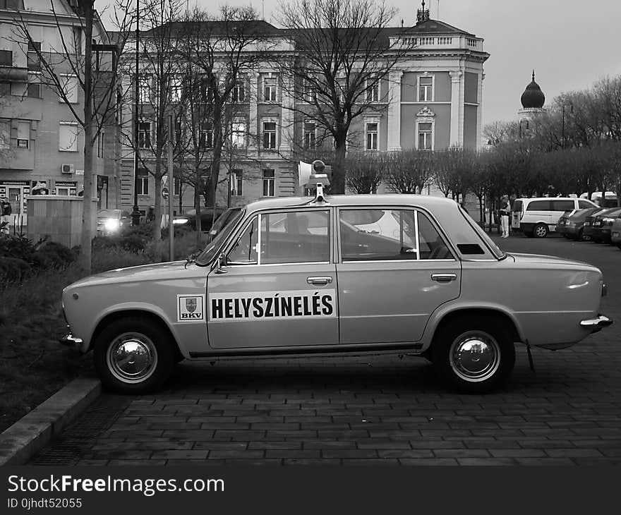 Sedan Near the Concrete Buidling