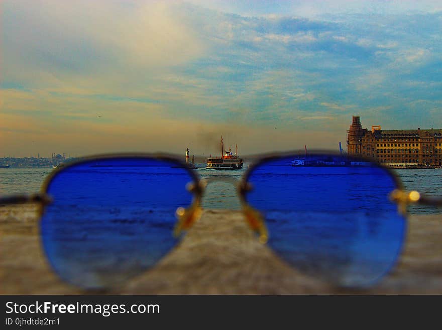 Blue Sunglasses With Black-frame on Concrete Stone