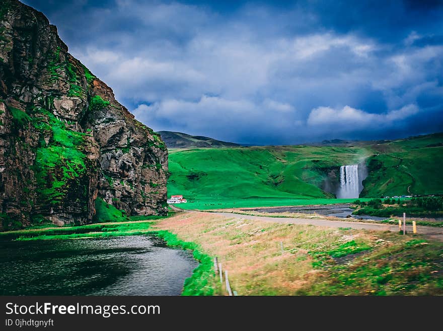 Body Of Water Near Grass Field