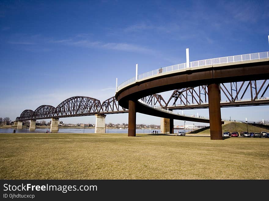 Low Angle Photography of Brown and Gray Bridge Under Blue Calm Sky