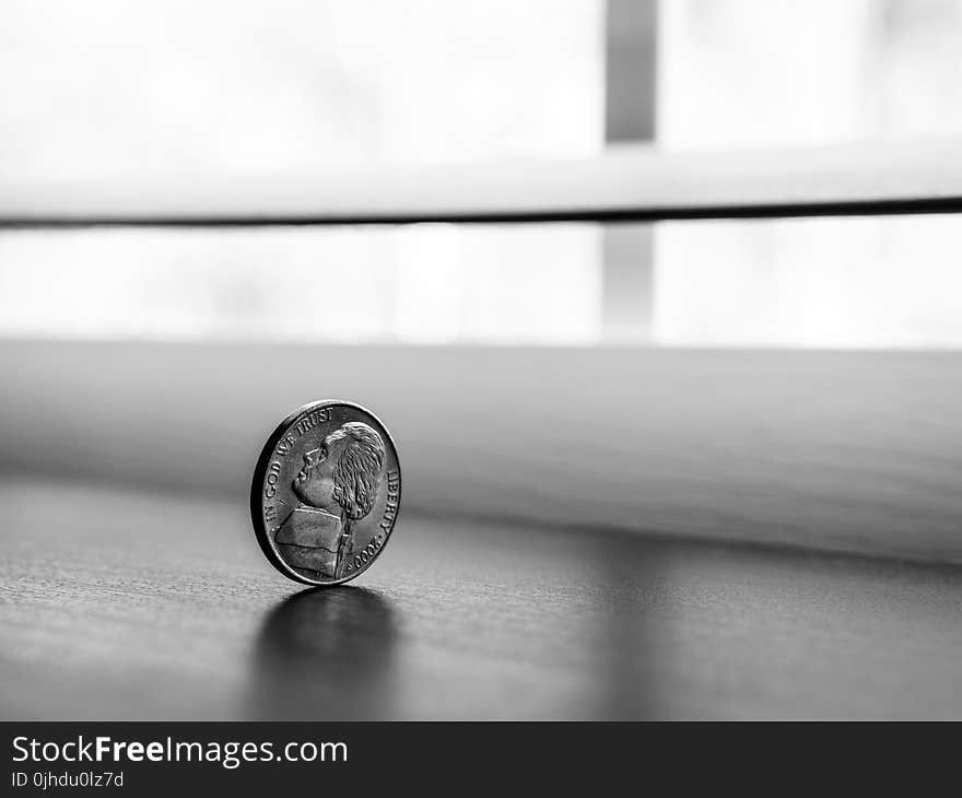 Monochrome Photography of Round Silver Coin