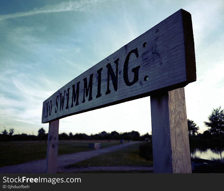 Brown and Black Wooden No Swimming Signage