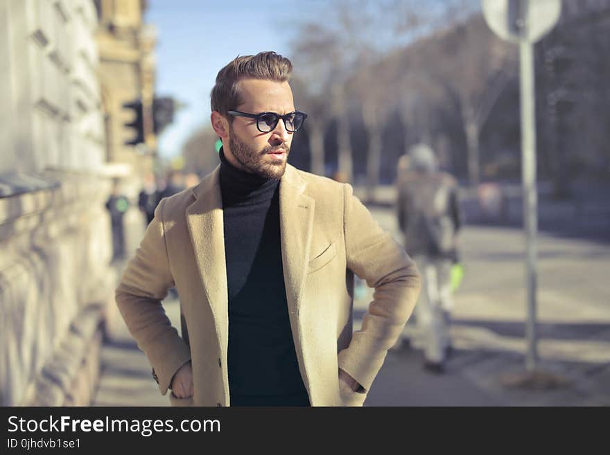 Selective Focus Photo of Man Wearing Black Turtleneck Top With Jacket on Road