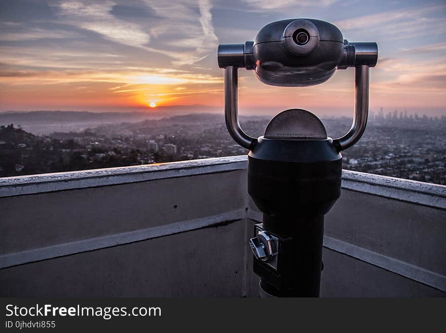 Coin-operated Tower Viewer on Rooftop during Sunset