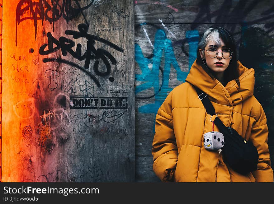 Woman in Yellow Coat With Black Crossbody Bag Closing Her Eyes