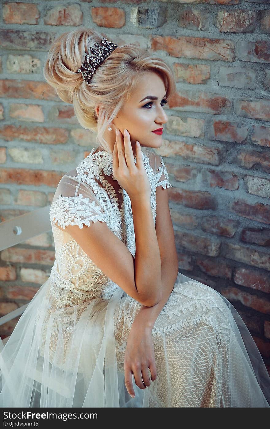 Woman in White Lace Dress Sits on Chair