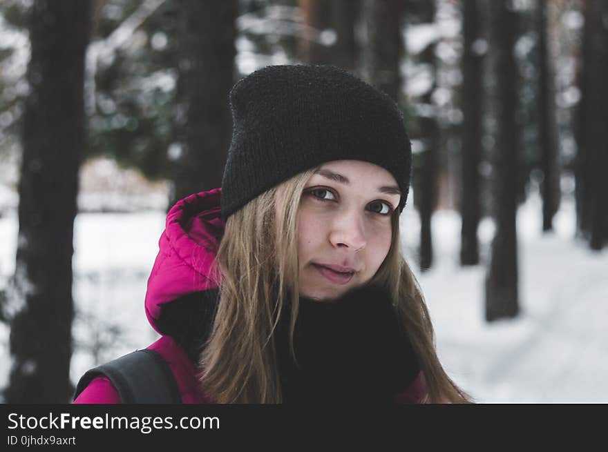 Woman in Pink and Black Jacket on White Snow